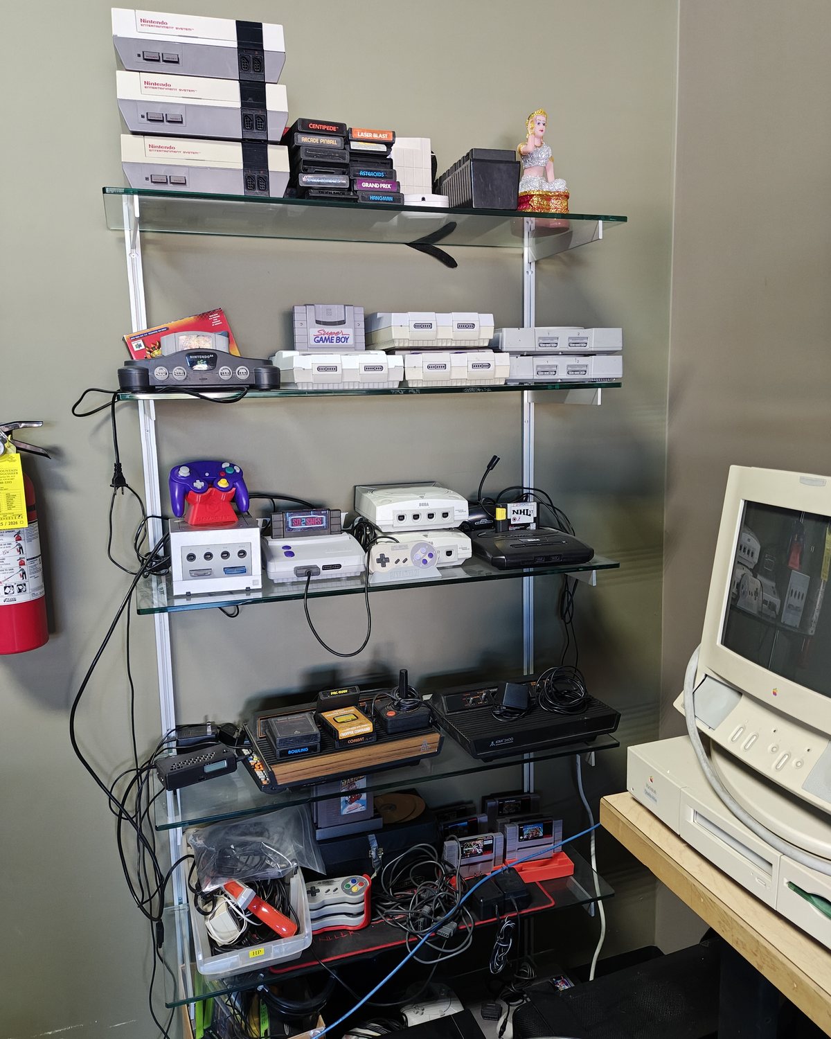 Retro consoles on the shelf at Advanced Computers: NES, SNES, N64, GameCube, Dreamcast and Atari
