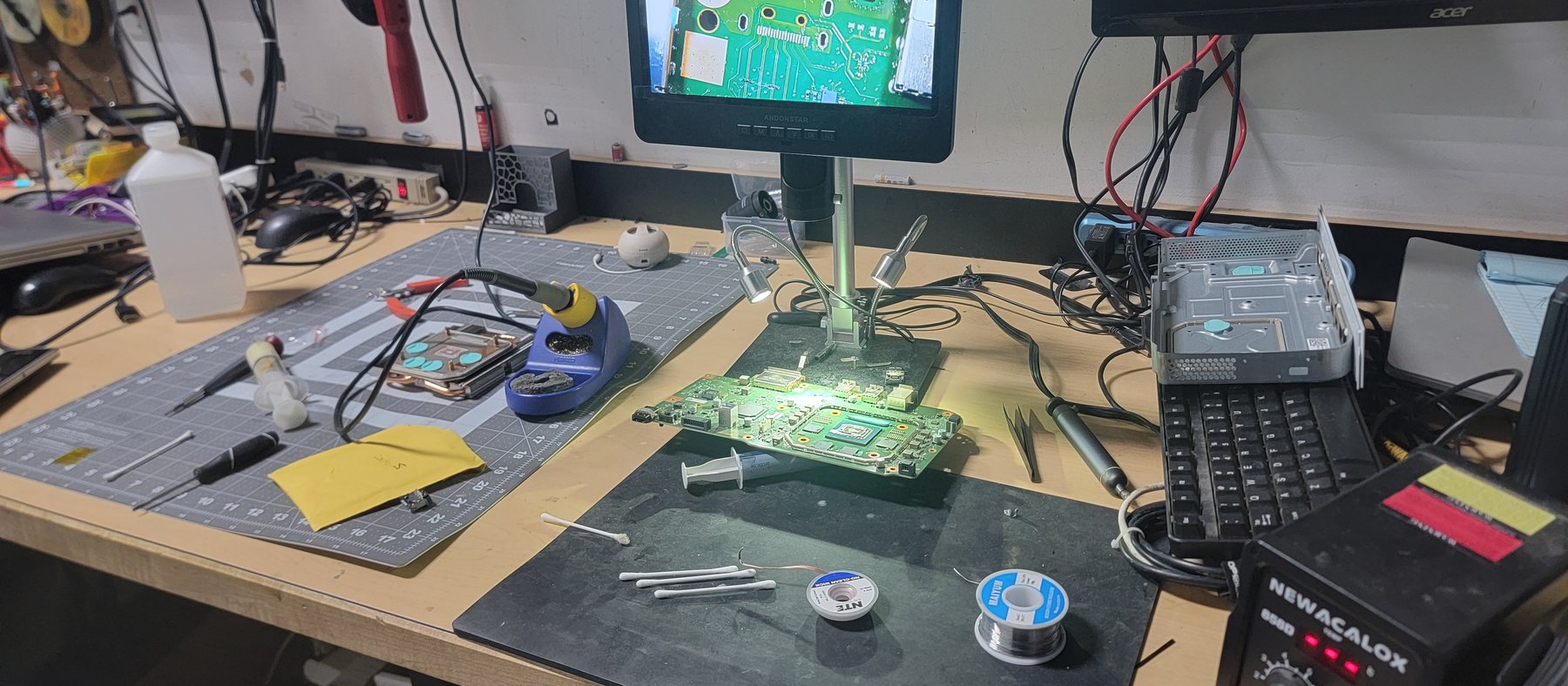 The board-level rework bench at Advanced Computers: digital microscope, hot air station and soldering iron